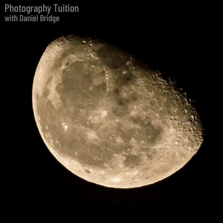 Photograph of a three quarter moon.